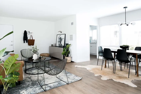 Living and dining areas with front door and kitchen entrance