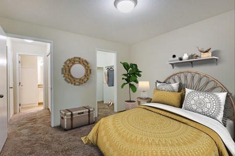 Carpeted bedroom with view to large wraparound closet.