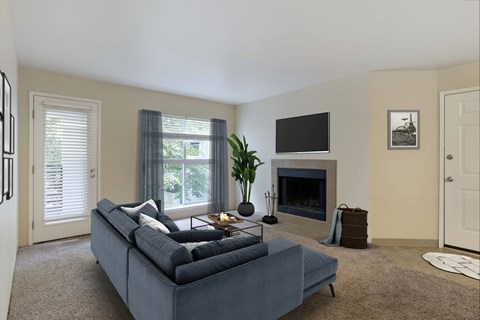 Carpeted living room with fireplace and large window.