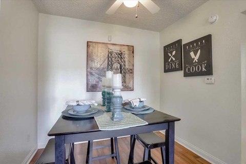 A dining room with a table set for two.