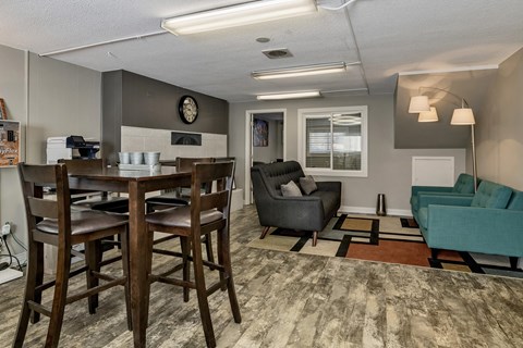 A community dining room with a wooden table and chairs.