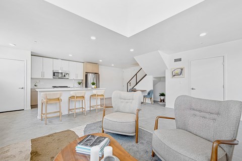 A living room with a grey couch and a coffee table with a book on it.