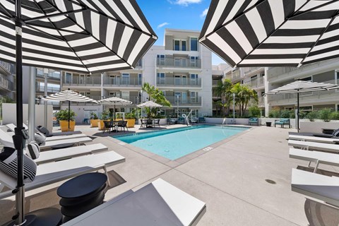 The pool area with sun loungers and umbrellas.
