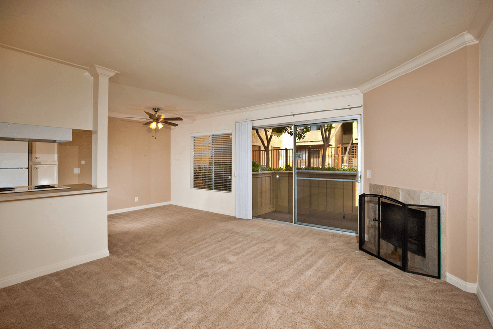 a living room with a fireplace and a door to a patio