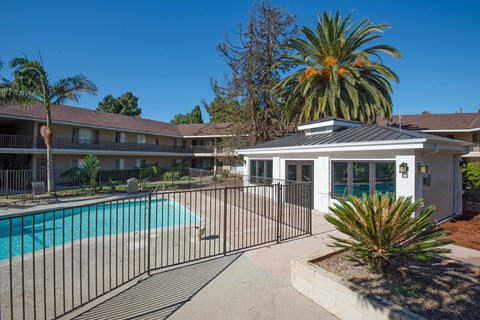 Gated pool area with the gym building in the background.