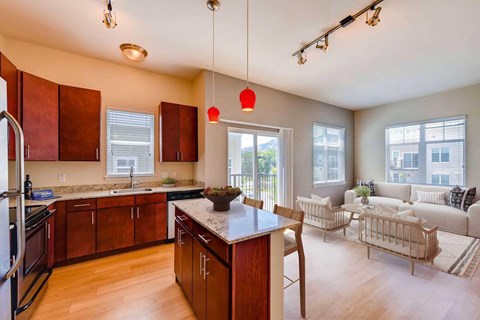 A kitchen with wooden cabinets and a granite countertop.