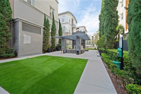 A grassy area in the community with the outdoor fireplace area in the background.