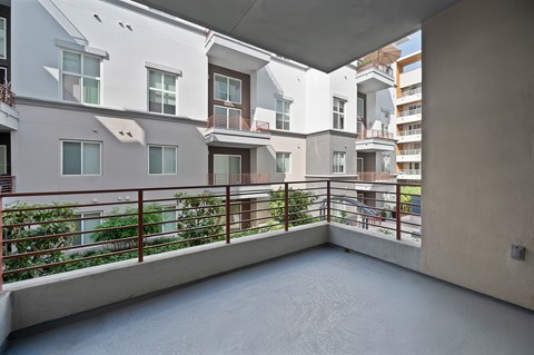 A large balcony with a railing.