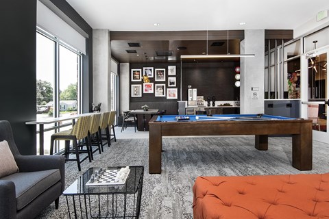 A modern living room with a pool table and a television.