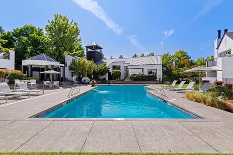 Pool with trees and community exterior.