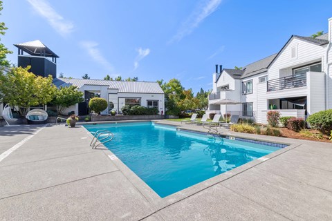 Pool and community exterior with trees surround.