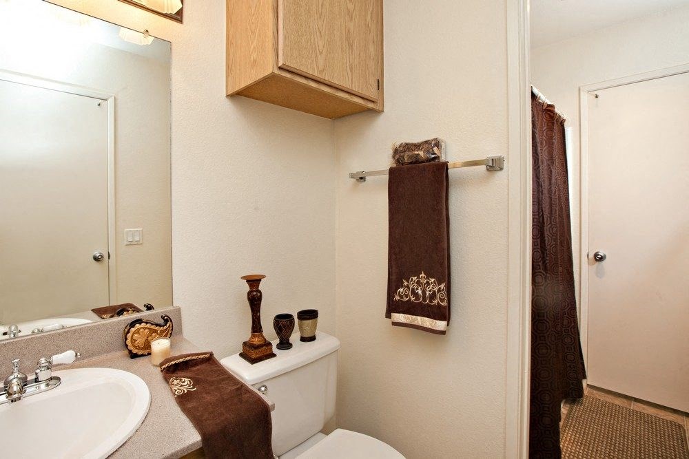 a bathroom with a toilet sink and shower