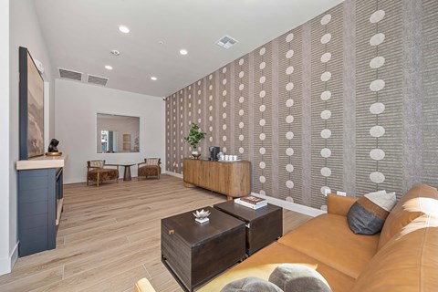Clubhouse with seating, tables, and textured accent wall.