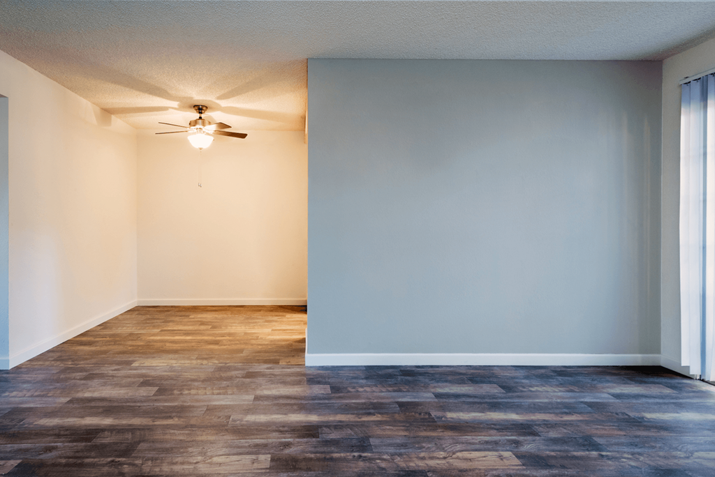 an empty room with a ceiling fan