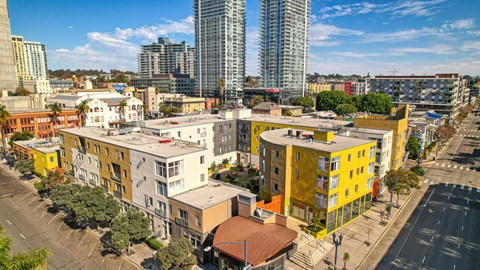 900 F Street against a cityscape with buildings in the foreground and a clear blue sky above.