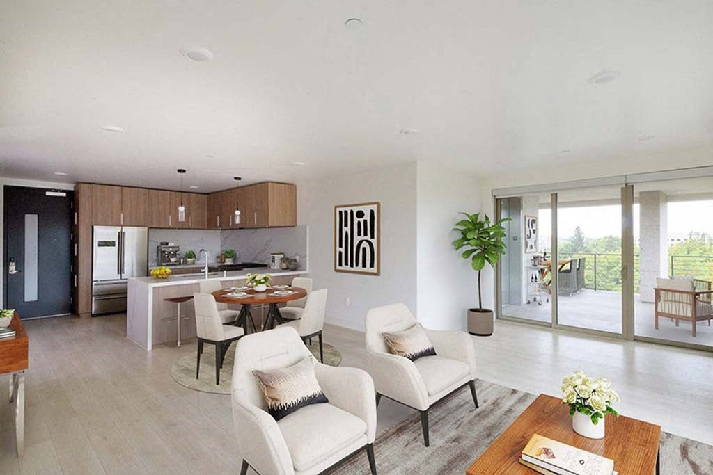 a living room and kitchen with a table and chairs