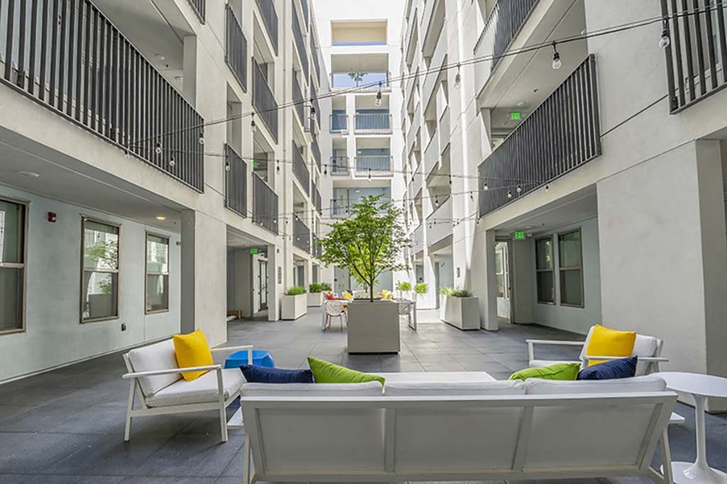 a living room filled with furniture and a large window