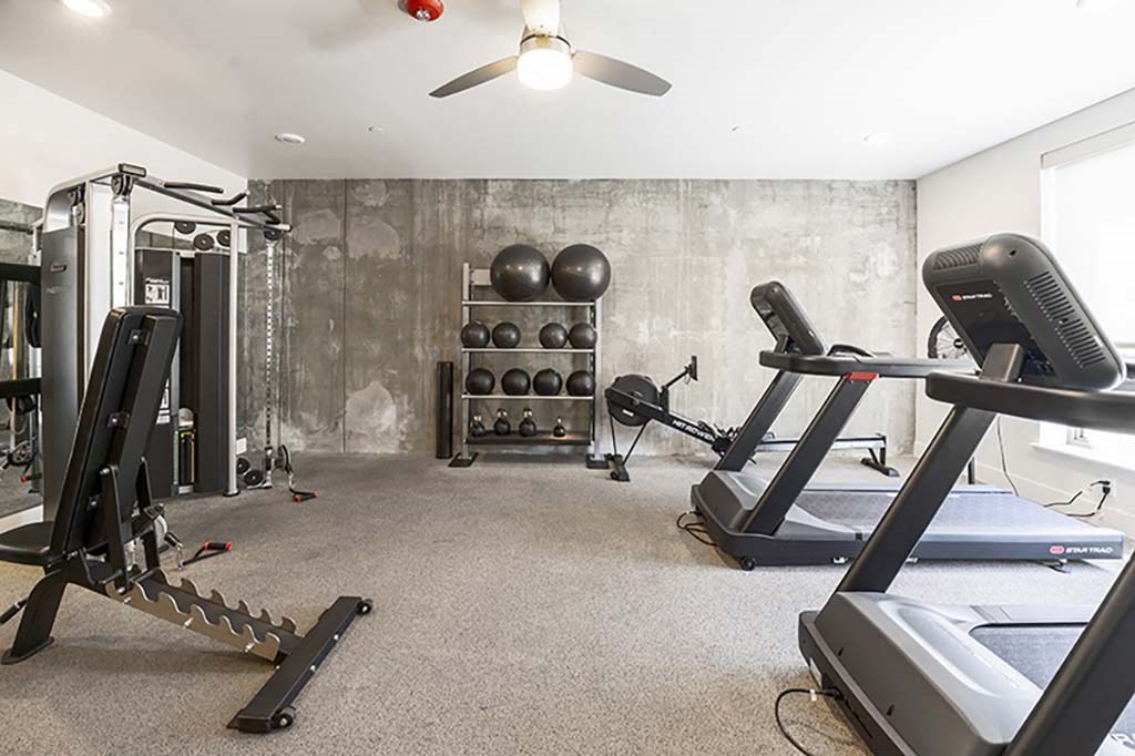 a home gym with treadmills and weights