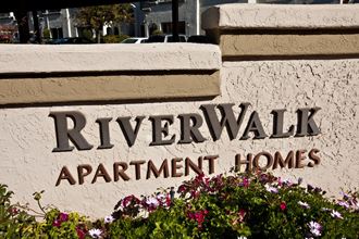 a sign that says riverwalk apartment homes