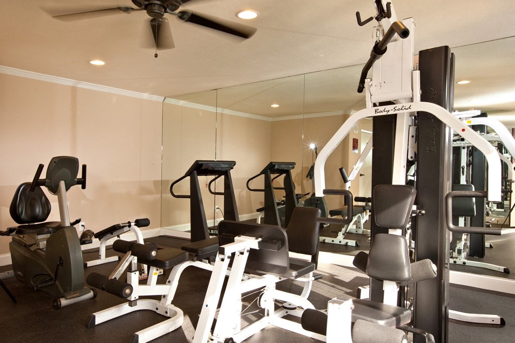 a room filled with lots of different types of exercise equipment