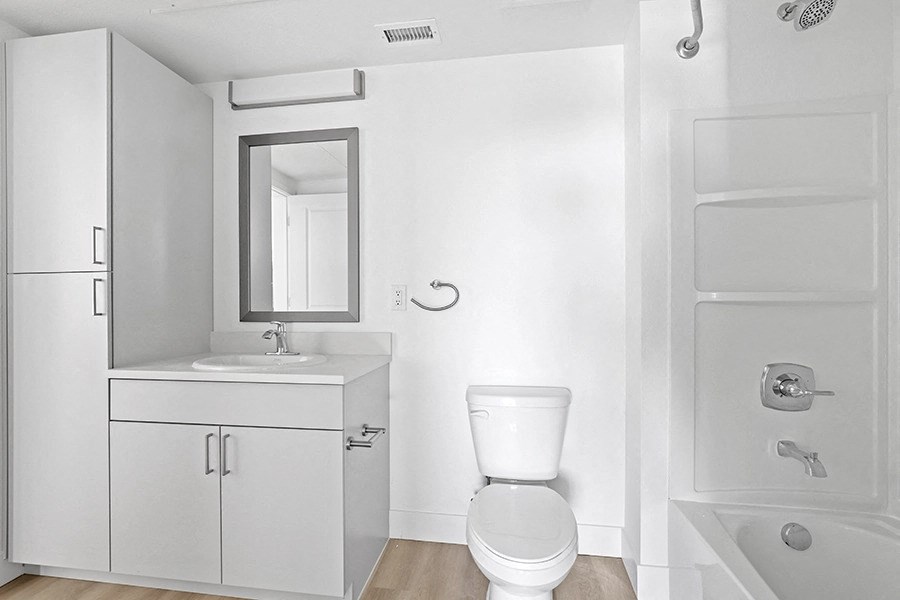 a white bathroom with a toilet and a sink
