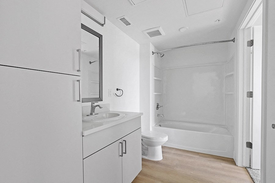 a white bathroom with a sink and a toilet