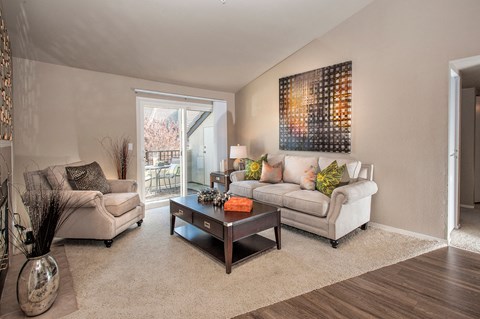 A living room with a couch, chair, and coffee table.