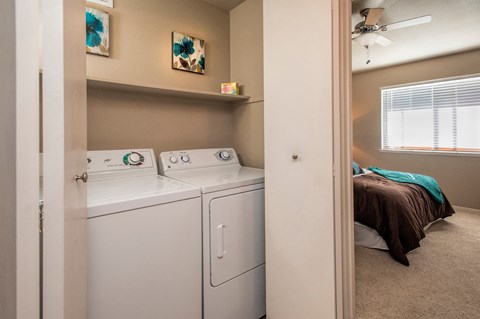 A small laundry room with a washer and dryer.