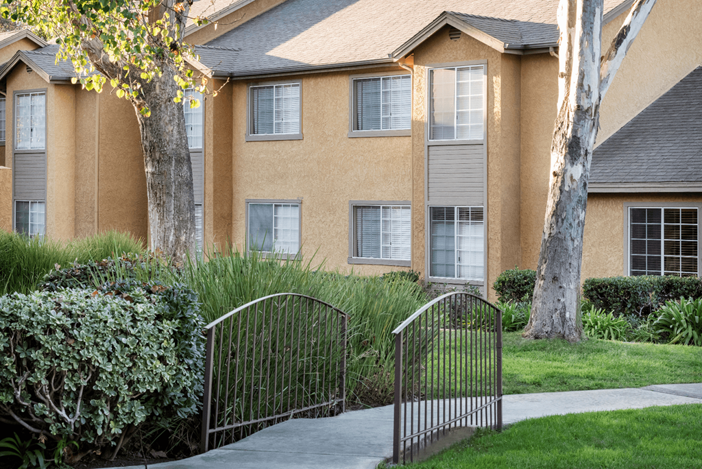 an apartment building with a metal gate in front of it