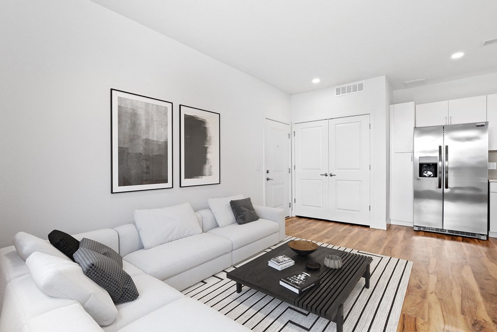 a living room with white couches and a coffee table