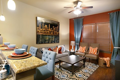 A living room with a dining table and chairs.