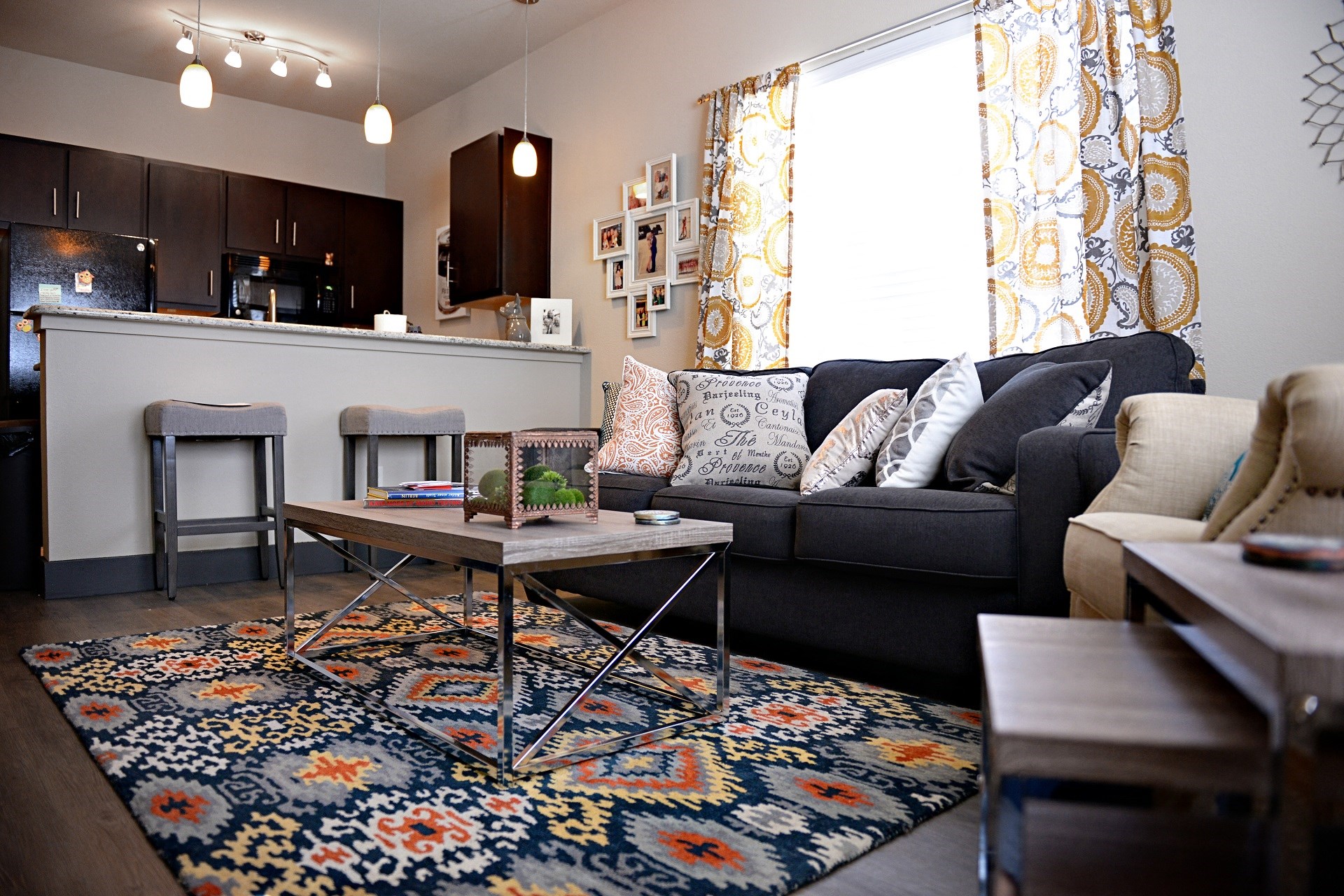 A living room with a black couch and a coffee table.