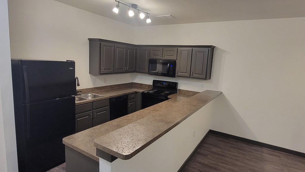 Kitchen with cabinets at The Talon, Denton, TX