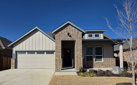 A house with a garage and a driveway.