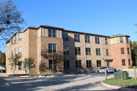 Modern apartment building exterior with brick facade at City Place Apartments, Denton, 76201
