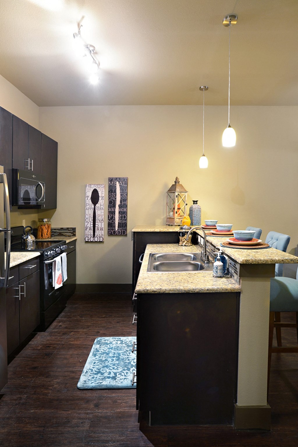 a kitchen with a sink and a counter top in a home at Urban Square, Denton, TX, 76210