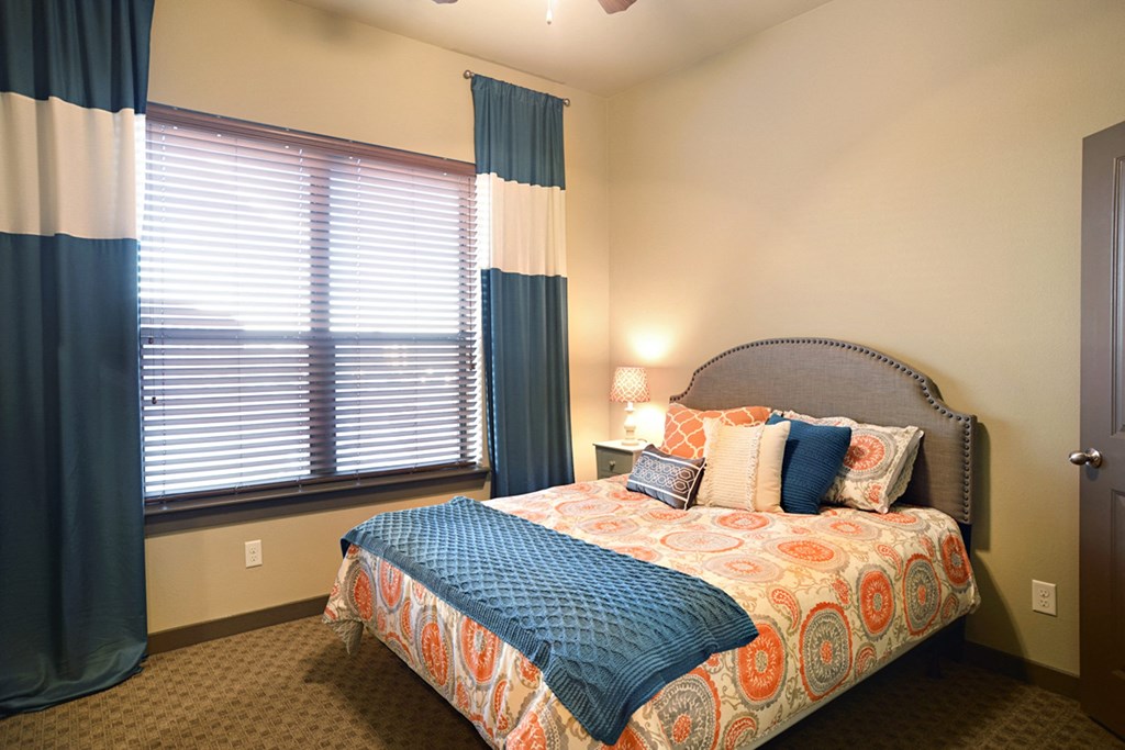 a bedroom with a bed and a large window at Urban Square, Denton, TX, 76210