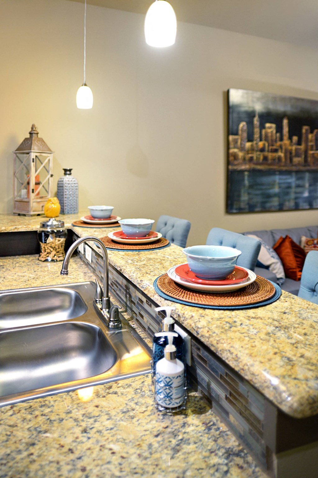 a kitchen with a sink and a counter with plates on it