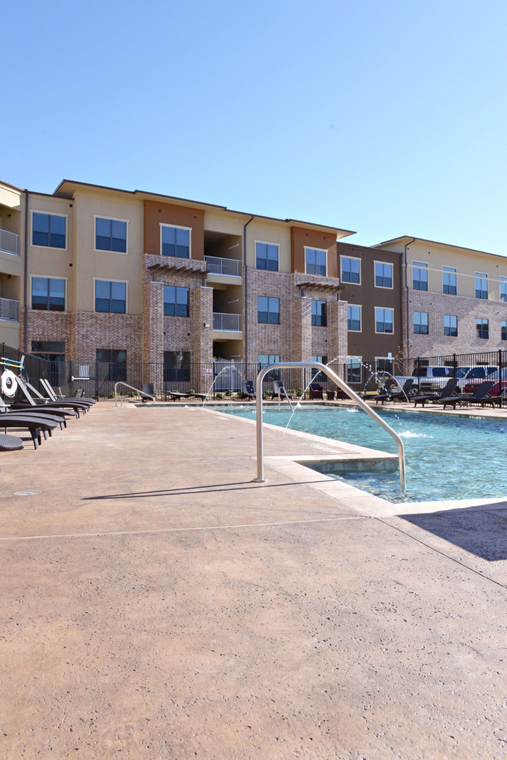 a swimming pool with a building in the background