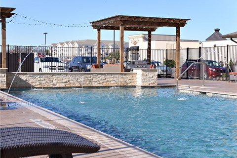 a swimming pool with a gazebo on the side of a hotel pool