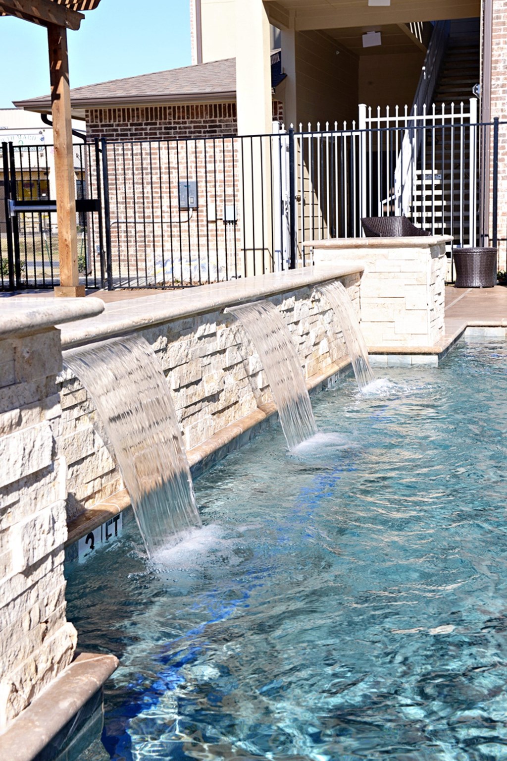 a water feature in a swimming pool at a resort at Urban Square, Denton, TX