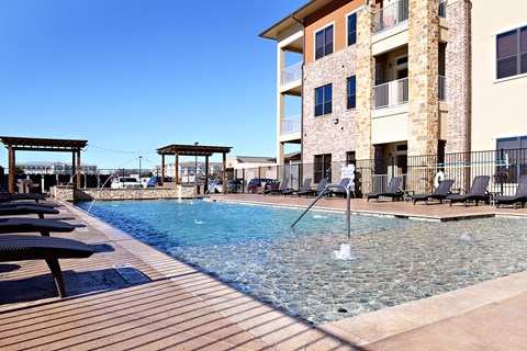 a swimming pool with a building in the background