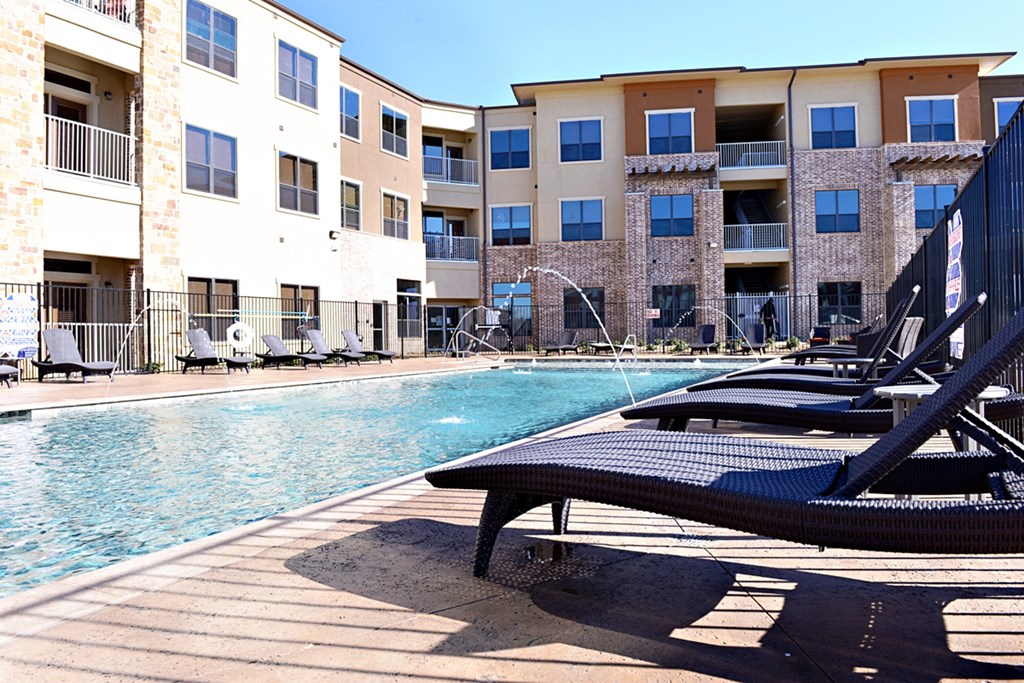 our apartments have a large pool and lounge chairs our apartments have a large pool and lounge chairs at Urban Square, Denton, TX, 76210