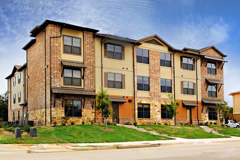 A large brick apartment building with multiple windows and balconies.