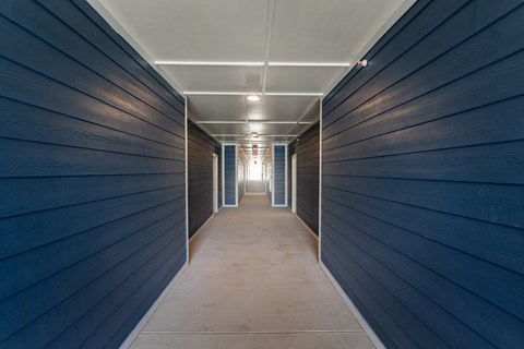 A long, narrow hallway with a light at the end.