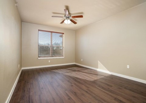 Empty bedroom with wood style flooring at City Place Apartments, Denton, TX 76201