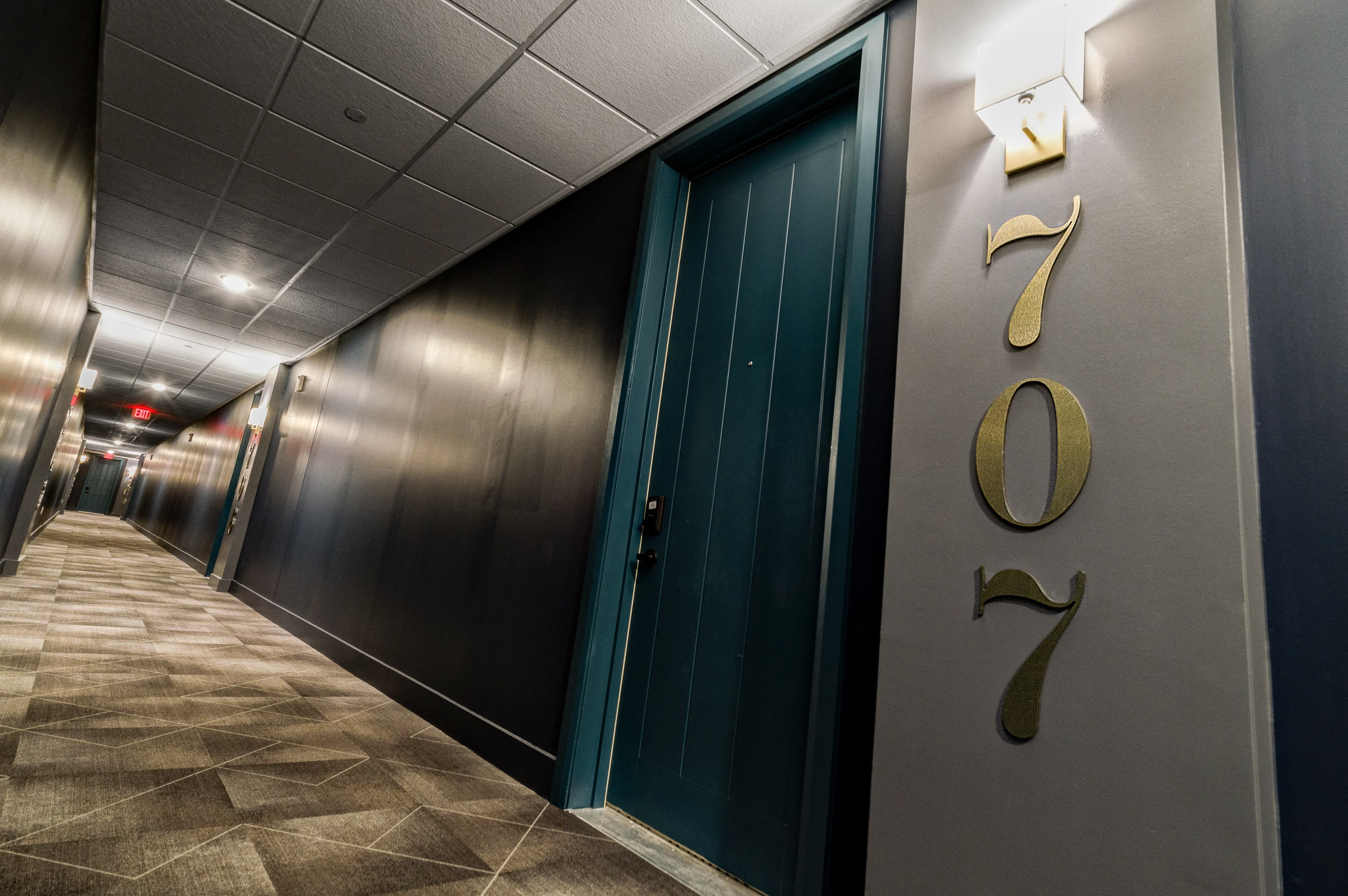 the hallway of a building with a hallway name on the side of a door