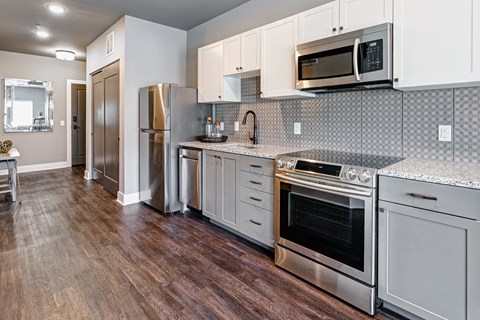 a kitchen with stainless steel appliances and white cabinets