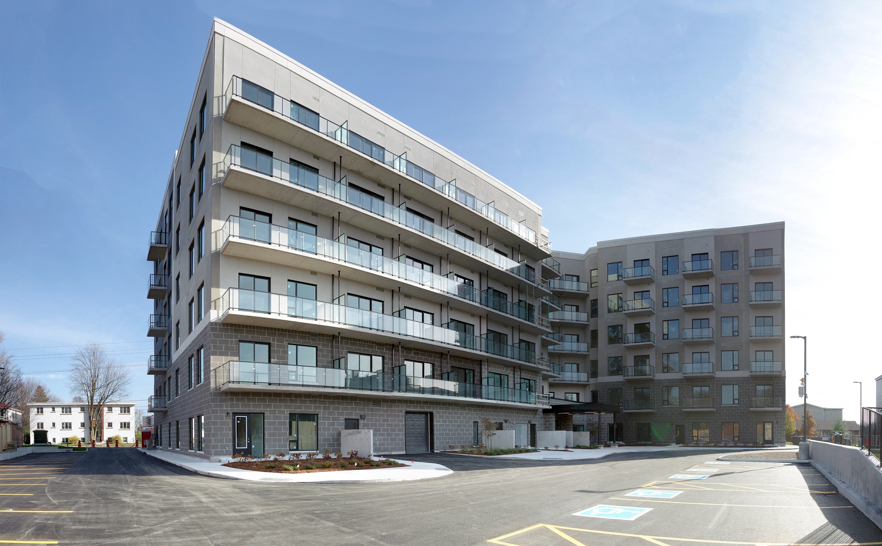 a view of the building from a parking lot with a blue sky