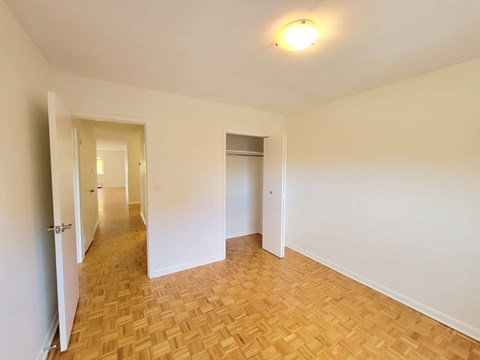 A room with a wooden floor and white walls.